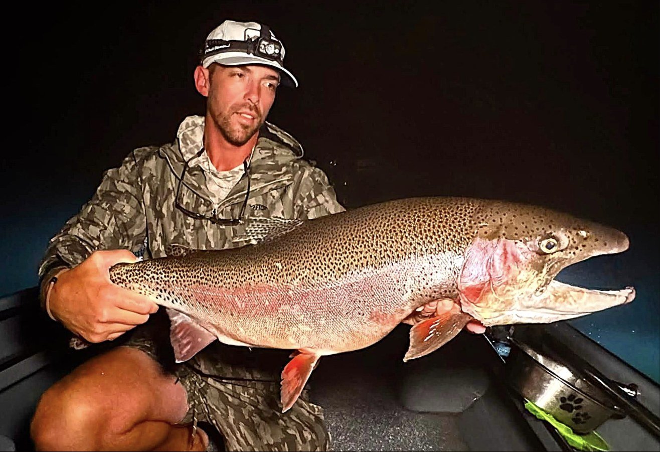 Guide Jesse Brison holding a 17 lb 7 oz rainbow trout caught on the White River